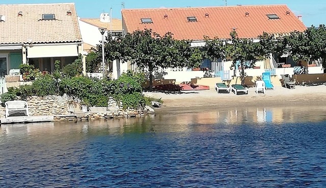 House on the edge of a marine pond close to the beach
